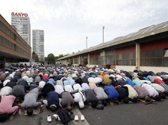 Muslims people pray in front of an old barrack in Paris on September 16, 2011 as part of friday's prayers. A ban on praying in French streets came into