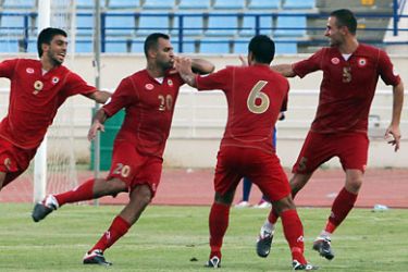 f_Lebanon's players celebrate after scoring a goal against the UAE during their 2014 World Cup Asia zone qualifying football match in Beirut on September 6, 2011.