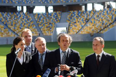 ف-UEFA President Michel Platini (2-R) speaks as Ukraine's Vice Prime Minister Borys Kolesnikov (R),