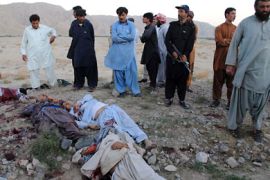 Local Pakistani residents gather around the bodies of Shiite Muslim pilgrims after an attack by gunmen in Mastung, a district 50 kilometres (30 miles) south of Quetta, the capital of the southwest Baluchistan province on September 20, 2011.