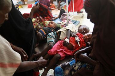 MOGADISHU, SOMALIA - AUGUST 20: Parents sit with their sick and malnourished children at the Banadir hospital on August 20, 2011 in Mogadishu, Somalia. The UN estimates that more than 100,000 Somalis have fled to Mogadishu from famine and drought in the countryside. The US government says that 30,000 children have died in Somalia due to the crisis in the last three months. (Photo by John Moore/Getty Images)