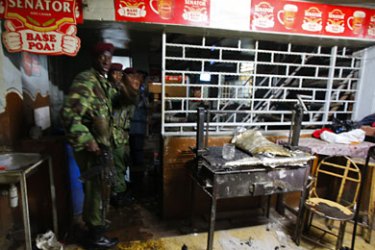 epa02978779 General Service Unit (GSU) police officers are seen at Mwaura's, the nightclub where a grenade was thrown injuring 14 people in downtown Nairobi, Kenya, on 24 October 2011