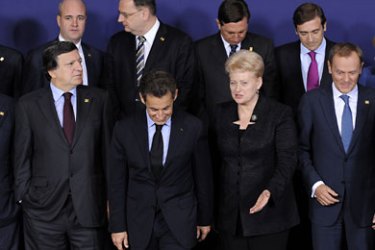 Lithuanian President Dalia Grybauskaite (2ndR) talks to French President Nicolas Sarkozy (C) under the look of European Commission President Jose Manuel Barroso (2ndL) as they pose for a family picture prior to an European Council at the Justus Lipsius building, EU headquarters in Brussels on October 23, 2011.