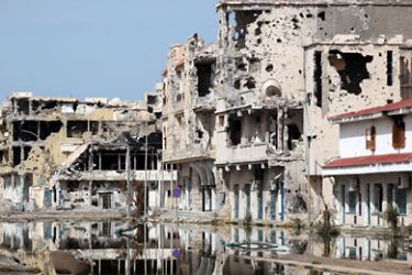 epa02976809 A general view of buildings ravaged by fighting in Sirte, Libya, on 22 October 2011. The tribe of slain Libyan leader Muammar Gaddafi urged the National Transitional Council on 22 Octopber to hand over his body to be buried in their hometown of Sirte according to Islamic rules. Gaddafi was captured alive on 20 October by council fighters in Sirte. Some witnesses said he was found hiding in a drainage pipe after a NATO airstrike on a convoy of alleged Gaddafi loyalists.