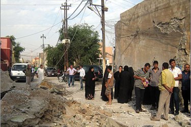 epa02969843 Iraqis inspect the damage at the headquarters of the National Turkman Front party after a bomb attack in Kirkuk, north of Iraq, on 17 October 2011. According to local sources, the attack killed one woman and injured 10 people including 4 children. EPA/KHALIL AL-A'NEI