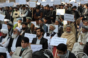 f_Afghan protesters hold up banners during a demonstration against a proposed US-Afghan strategic security agreement in Kabul on October 24, 2011