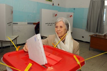 f_A woman casts her vote on October 23, 2011, at a polling station in Tunis. Polls opened in Tunisia's first-ever free elections, with an Islamist party poised to win nine months