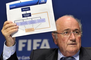 FIFA president Joseph Blatter holds the structure of the new "Committee of Good Gorvernance" during a press conference following an executive October 21, 2011 at the FIFA headquarters in Zurich. Issues including the recent corruption scandal, as well as preparations for the 2014 World Cup were on the agenda. AFP PHOTO / FABRICE COFFRINI