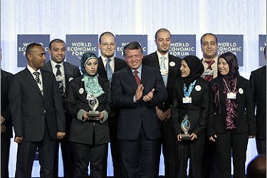 King Abdullah II of Jordan (C) poses for a picture with winners of the King Abdullah Award on the second day of the World Economic Forum (WEF) in the Dead Sea, 55 kms southeast of Amman, on October 23, 2011. AFP PHOTO/KHALIL MAZRAAWI