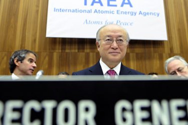 International Atomic Energy Agency (IAEA) Director-General Yukiya Amano (C) smiles during the board of governors conference at the agency headquarters in Vienna on November 17, 2011