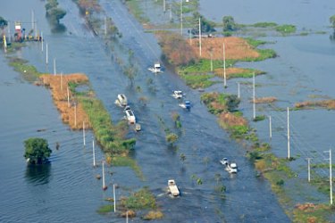 vehicles travelling on a flooded highway in a suburb of Bangkok on November 19, 2011