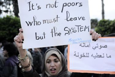 A Moroccan woman holds a sign as she takes part in a demonstration march in Marrakech, on November 20, 2011, in support of the "February 20 Movement" 's call to boycott the upcoming legislative elections. Morocco has opened its campaign for November 25 legislative elections, with moderate Islamists seen as possible winners and fears of a low turnout in the country's second vote this