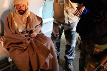 Saif al-Islam Gaddafi is pictured sitting in a plane in Zintan November 19, 2011. Saif al-Islam Gaddafi told Reuters on Saturday that he was feeling fine after being captured by some of the fighters who overthrew his father and he said injuries to his right hand were suffered during a NATO air strike a month ago.