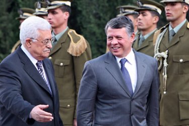 Palestinian leader Mahmud Abbas (L) and Jordanian King Abdullah II (R) review the honour guard during a welcome ceremony in the West Bank city of Ramallah on November 21, 2011. King Abdullah II landed in Ramallah for talks with Mahmud Abbas in his first visit in more than a decade. AFP PHOTO/AHMAD GHARABLI