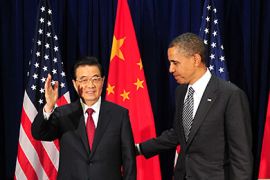 Honolulu, Hawaii, UNITED STATES : Chinese President Hu Jintao (L) waves with US President Barack Obama (R) at the end of their bilateral meeting on the sidelines of the Asia-Pacific Economic Cooperation (APEC) summit in Honolulu, Hawaii, on November 12, 2011. The United States is hosting this year's APEC forum for the first time since 1993, with leaders from the 21 member economies convening on the island of Oahu on November 12-13. AFP PHOTO
