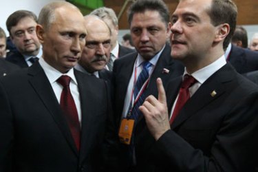 Russia's President Dmitry Medvedev (R) and Prime Minister Vladimir Putin (L, front) speak during a United Russia party congress in Moscow November 27, 2011. Vladimir Putin accepted his ruling United Russia party's nomination on Sunday as its candidate in a March 4 presidential vote, paving the way for his return to the country's top office after four years as prime minister.