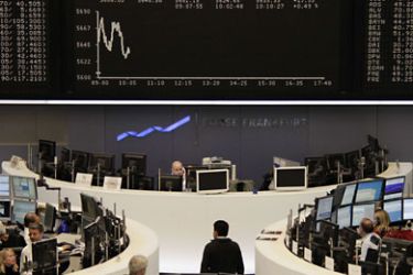 r_Traders are pictured at their desks in front of the DAX board at the Frankfurt stock exchange November 22, 2011. REUTERS