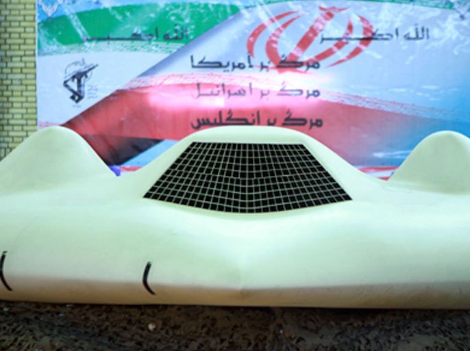 An undated picture received December 8, 2011 shows a U.S. RQ-170 unmanned spy plane displayed in front of a flag with Persian script that reads "Down with the U.S. (top