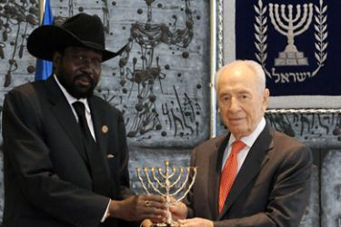 A picture released by the Israeli Government Press Office (GPO) shows South Sudan's President Salva Kiir (L) receiving a Hanukkah Menorah from Israeli President Shimon Peres in Jerusalem on December 20, 2011