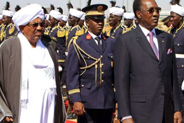 President Omar al-Bashir (L) and his Chadian counterpart Idriss Deby (R) review the guard of honour upon the latter's arrival at Khartoum airport on December 5, 2011. AFP PHOTO / ASHRAF SHAZLY