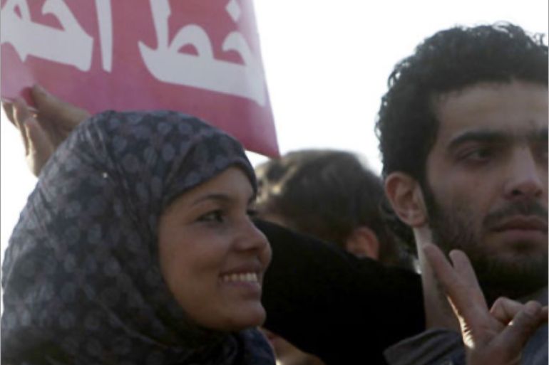 Samira Ibrahim (L) flashes a victory sign as she attends a protest against military council violations and virginity tests against females at Tahrir Square in Cairo, December 27, 2011. An Egyptian court ordered on Tuesday that forced virginity tests be stopped on female detainees in military prisons. Ibrahim said the army forced her to undergo a virginity test in March after she was arrested during a protest in Cairo's Tahrir Square. REUTERS/Amr Abdallah Dalsh (EGYPT - Tags: CIVIL UNREST POLITI