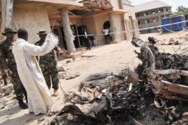 epa03042972 Security forces inspect the damage after a car bomb exploded at the St Theresa's Catholic Church in Madalla, near Abuja, Nigeria, 25 December 2011