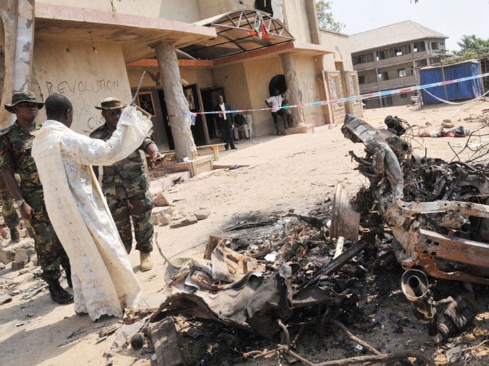 epa03042972 Security forces inspect the damage after a car bomb exploded at the St Theresa's Catholic Church in Madalla, near Abuja, Nigeria, 25 December 2011