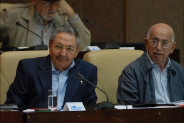 Cuban President Raul Castro (L) and First Vice-President Jose Ramon Machado attend the second annual session of the National Assembly