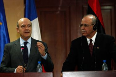 Libya's Prime Minister Abdurrahim El-Keib (R) listens as French Foreign Minister Alain Juppe speaks at a news conference in Tripoli December 14, 2011. France will release 230 million euros ($300 million) to Libyan authorities in the next few days and help them recover the rest of their frozen assets, Juppe said on a visit to Tripoli on Wednesday.