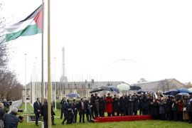 Palestinian President Mahmoud Abbas (C), UNESCO Director General Irina Bokova and officials attend the flag-raising ceremony for the Palestinian flag at the UNESCO Headquarters in Paris December 13, 2011.