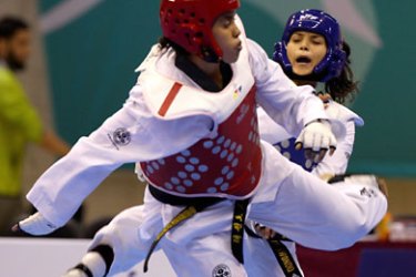 ف-Khaoula ben Hamza (blue) of Tunisia faces Salima Boulagtab of Morocco during their women's under 73kgs Taekwondo