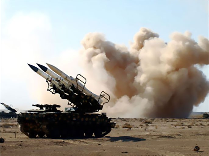 A handout picture released by the official Syrian Arab News Agency (SANA) on December 20, 2011 shows smoke billowing behind a missile launcher during military manoeuvres by the Syrian army in an undisclosed location in Syria. The Syrian navy and air force conducted live-fire