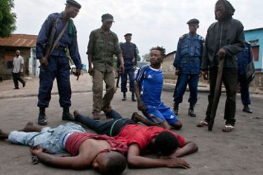 Policemen detain opposition supporters demonstrating in the streets of Kinshasa on December 10, 2011, after the CENI (National Independent Electoral Commission) announced the day before the re-election of President Joseph Kabila. Tensions escalated in the Democratic Republic of Congo's electoral standoff Saturday as the government threatened to prosecute runner-up Etienne Tshisekedi for declaring himself