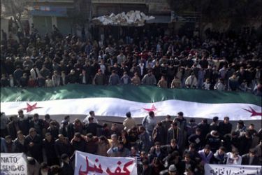 r : Demonstrators protest against Syria's President Bashar al-Assad in Kafranbel, near Adlb December 30, 2011. Syrian security forces, undaunted by the presence of Arab League observers, have killed at least 12 protesters as hundreds of thousands demonstrated against the government of