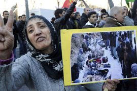 woman shows a photograph during a demonstration of members of the Kurdish community in France on December 30, 2011 in Marseille, southern France, to protest against an air strike in southeastern Turkey that killed 35 Kurdish villagers