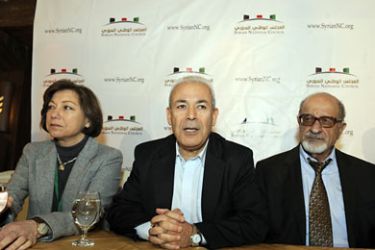 Syrian-French political scientist, professor and President of the Syrian National Council (SNC), Burhan Ghaliun(C) arrives with members Basma Gadhmani (L) and prominent Syrian human rights activist and government critic, Haitham al-Maleh(R) at a press conference on December 19,