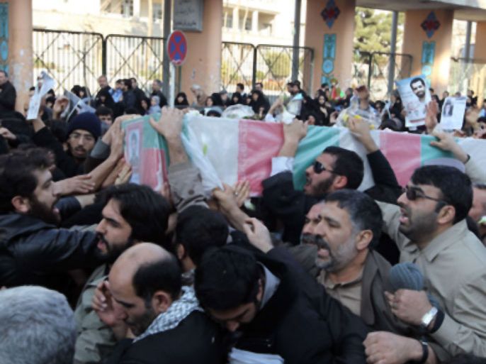 Mourners carry the coffin of Iranian nuclear scientist Mostafa Ahmadi-Roshan, during his funeral in Tehran on January 13, 2012, one day after he was killed when two men on a motorbike slapped a magnetic bomb on his car while it was stuck in Tehran traffic.
