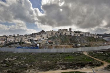 A general view shows the Palestinian Shuafat refugee camp behind Israel’s controversial separation barrier in east Jerusalem on January 19, 2012.