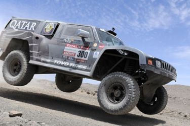 ف- Qatar's driver Nasser Al-Attiyah steers his Hummer during the stage 8 of the Dakar Rally 2012