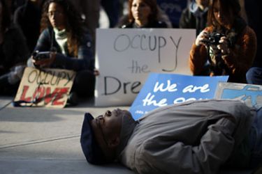 Activists with Occupy Los Angeles and African American faith and clergy community members pray as they come together to hold an Occupy the Dream rally in honor of American civil rights icon Dr. Martin Luther King outside the Los Angeles Federal Reserve Bank offices on Martin Luther King Day in Los Angeles, California January 16, 2012.