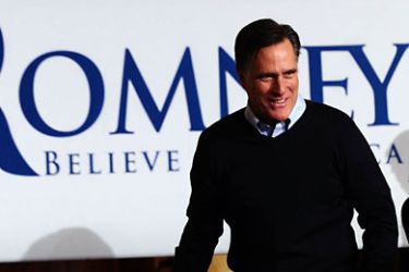 Republican presidential hopeful Mitt Romney arrives on stage to speak during a campaign rally in Des Moines, Iowa, on January 3, 2012.
