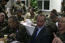 afp : French Defence Minister Gerard Longuet (C) sings with French soldiers at Forward Operating Base (FOB)Tora in Surobi Province of Afghanistan early January 1, 2012. French defence minister Gerard Longuet spent New Year's eve with troops in Afghanistan at the end of a year in which his nation's forces suffered their heaviest death toll. Longuet saw in the new year with military personnel based in Surobi, a district of Kabul province to the east of the capital. AFP PHOTO/Joel SAGET
