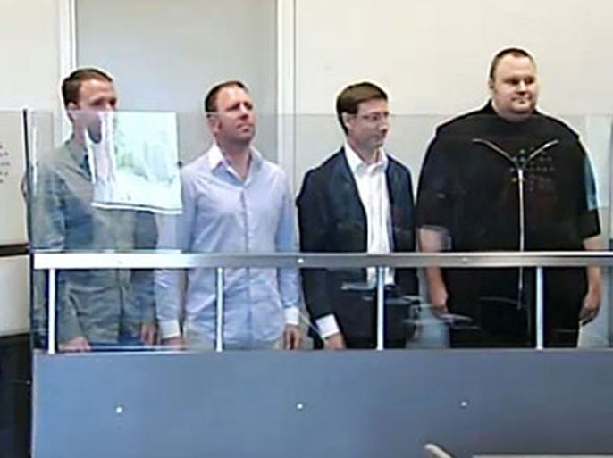 This TV grab shows Internet guru and founder of Megaupload.com, Kim Schmitz (R), also known as "Kim Dotcom" at a court in Auckland in New Zealand on January 20, 2012. Schmitz, alleged by US authorities to be involved in one of the largest cases of copyright theft ever, was denied bail with three other men, police said. US authorities are seeking their extradition to the United States. AFP PHOTO/ TV3