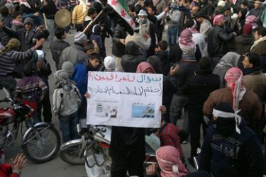 Demonstrators protest against Syria's President Bashar al-Assad in Yabroud December 30, 2011. Banner read, "Question to Arab League observers? You came to the genocide of the people or to save the people?" Picture taken December 30, 2011.