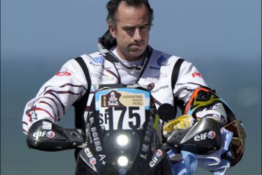 afp : Argentina's Jorge Martinez Boero rides his Beta on the podium during the symbolic start of the 2012 Dakar Rally in Mar del Plata, some 400 Km south of Buenos Aires, on December 31, 2011. Martinez Boero died on January 1, 2012 in an accident during the first stage of the Rally. AFP PHOTO/JUAN MABROMATA