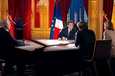 A TV grab taken from French TV channel TF1 shows France's President Nicolas Sarkozy (C) and journalists (Lto) Francois Lenglet (hidden), Jean-Marc Sylvestre, Laurent Delahousse and Claire Chazal during the hour-long television interview, on January 29, 2012, focused on France's situation and broadcasted on TF1