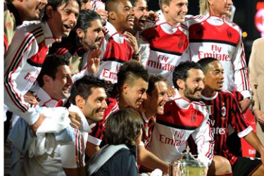 AC Milan's players celebrate after winning the Challenge Cup football match against Paris Saint-Germain at Al-Rashed Stadium in Dubai on January 4, 2012.