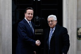 Britain's Prime Minister David Cameron (L) greets Mahmoud Abbas, the President of Palestinian Authority outside 10 Downing Street in central London, January 16, 2012.