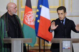 Afghan's president Hamid Karzai (L) listens to France's President Nicolas Sarkozy (R) speaking during a press conference with his at the presidential Elysee palace on January 27, 2012 in Paris. Karzai met Sarkozy a week after the French leader threatened to pull his troops out of Afghanistan. AFP PHOTO