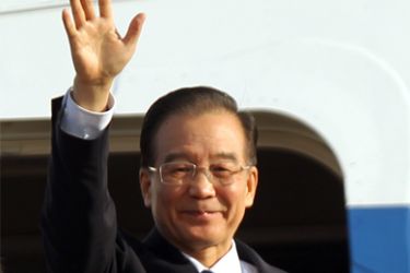 epa03006255 Chinese Premier Wen Jiabao waves as he